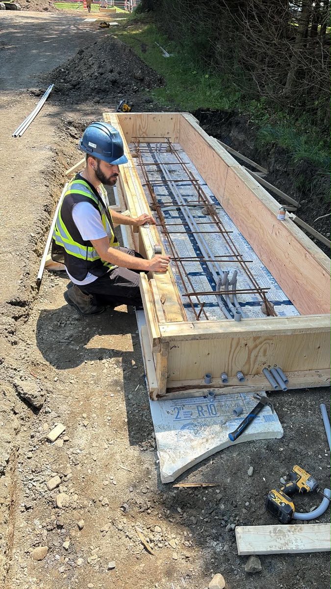 Field team preparing concrete and conduits for an access-control installation